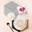 iLOVE 70% Cocoa Dark Belgian Chocolate displayed with a cappuccino and marshmallows