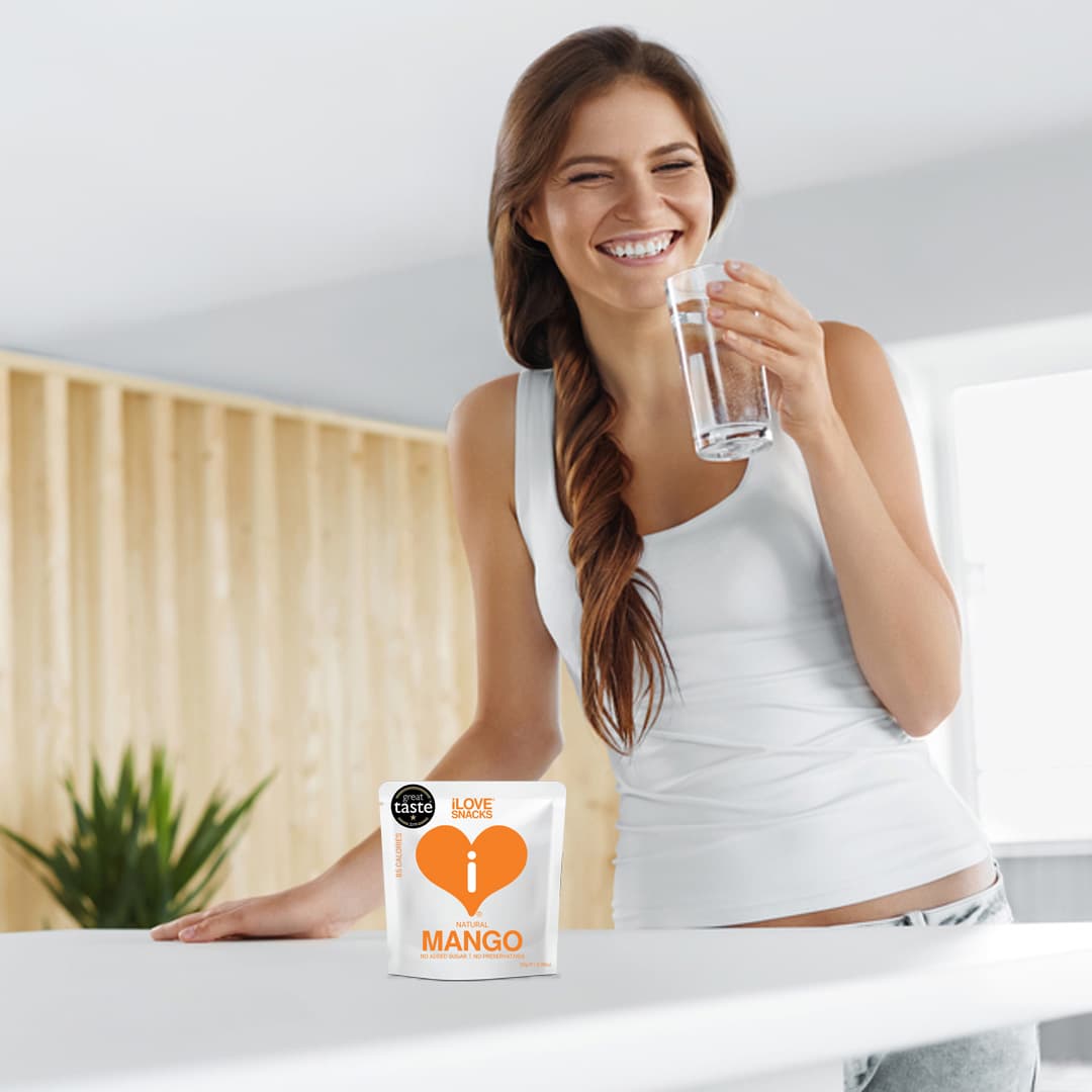 Woman enjoying iLOVE Gently Dehydrated Mango snacks